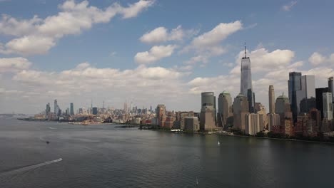 a bird's eye view over upper bay with water vessels moving by in the hudson river below