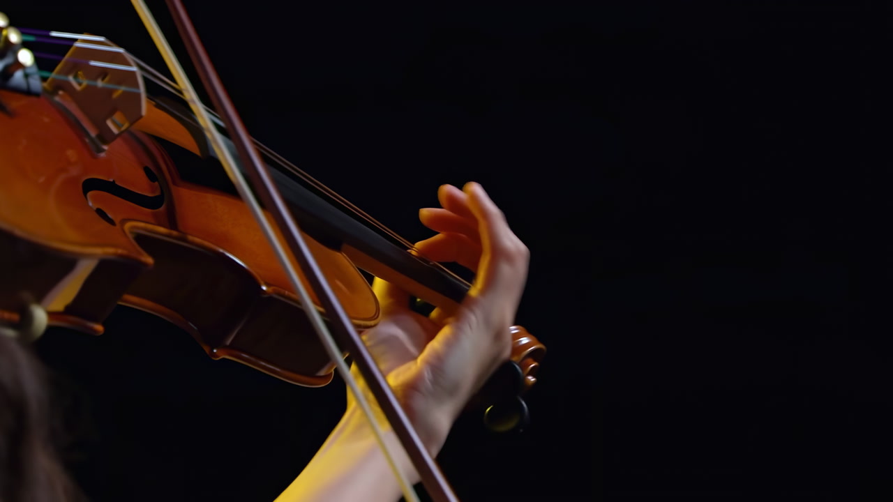 Closeup Violin Hand On Strings, Cinematic Bowing Under Warm Stage Lighting Against Black Background, Precise