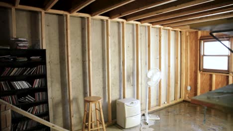 a naturally lit, unfinished room with some furniture