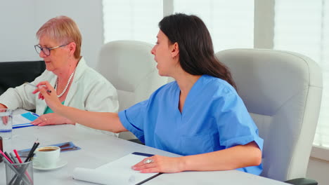 close up of medical nurse taking notes on clipboard during