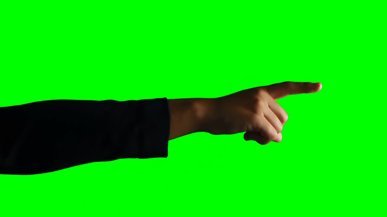 Person making hand gesture against green screen background