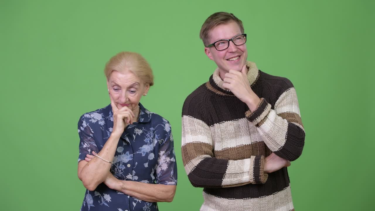Happy grandson and worried grandmother thinking together