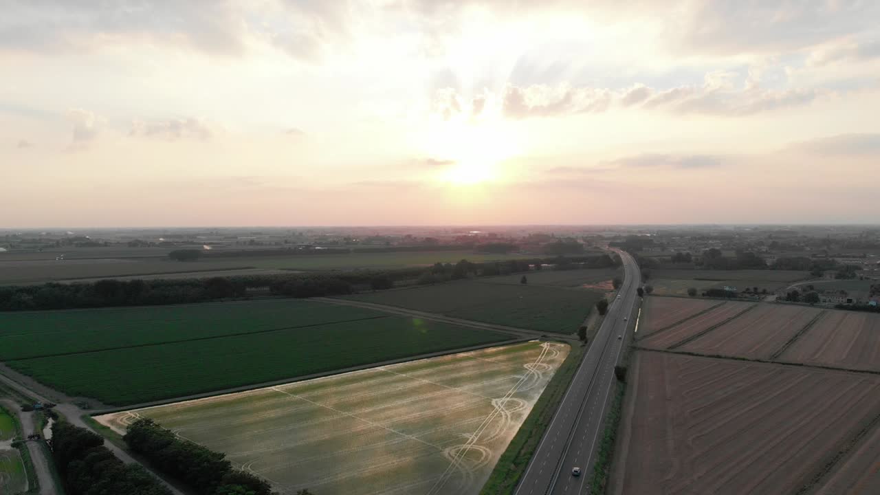 Aerial view of a highway(autostrada) in Italy amid fields.