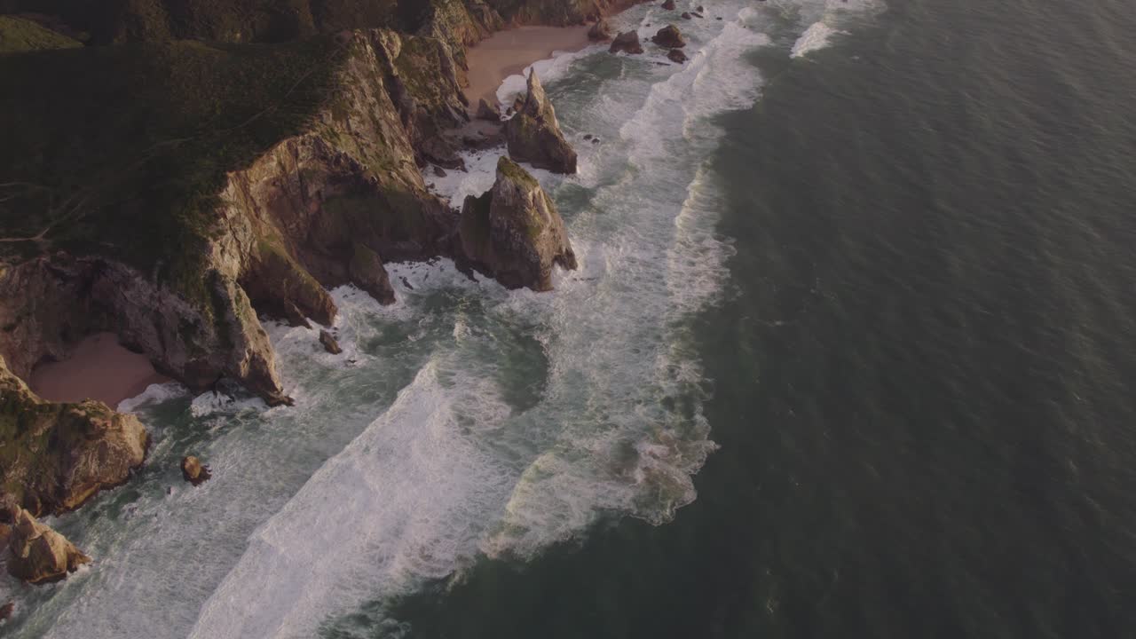 Aerial view of rough coast line high cliffs at Cabo da Roca during sunset, drone shot