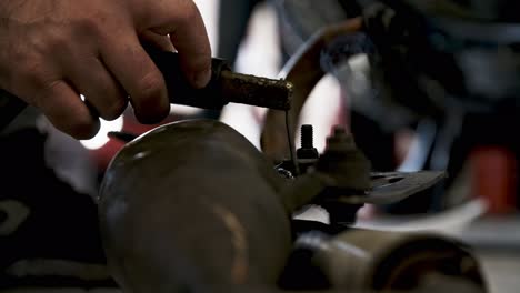 Hot-sparks-and-white-light-while-welding-metal-screws-in-close-up-view