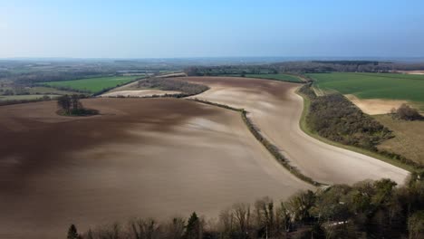 High-altitude-wide-angle-aerial-shot-of-fields-and-farmland-in-Britain