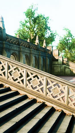 stone steps and railing leading up to a stone archway in a park