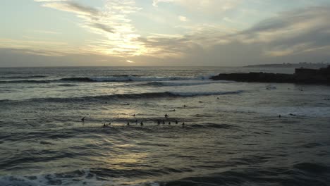 4k-footage---Aerial---drone-view-of-many-surfers-waiting-for-the-waves-to-come