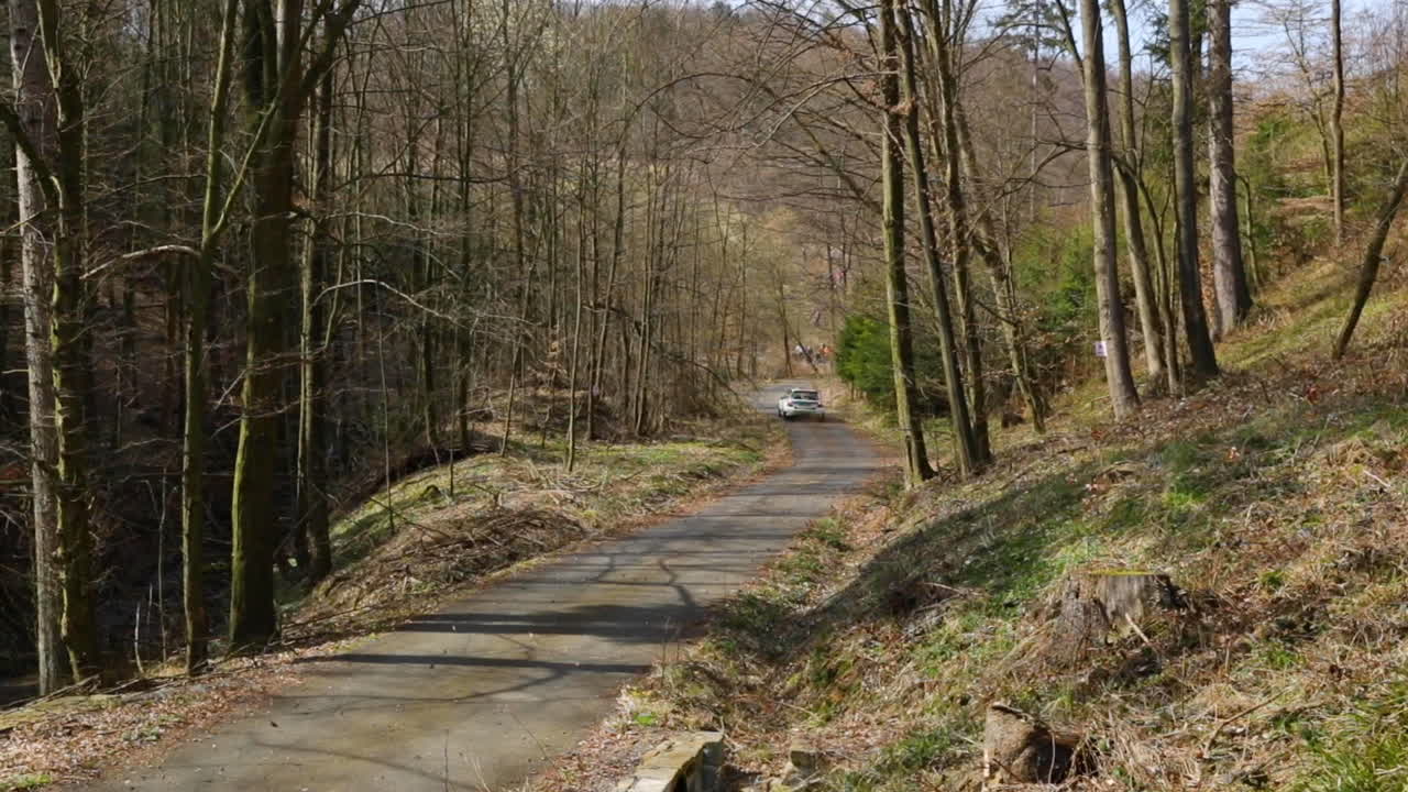 The Valasska Rally and Skoda Fabia passage in a pair of short, light turns from the back of the car leave leaves and stones flying through the forest captured in 120fps slow motion.
