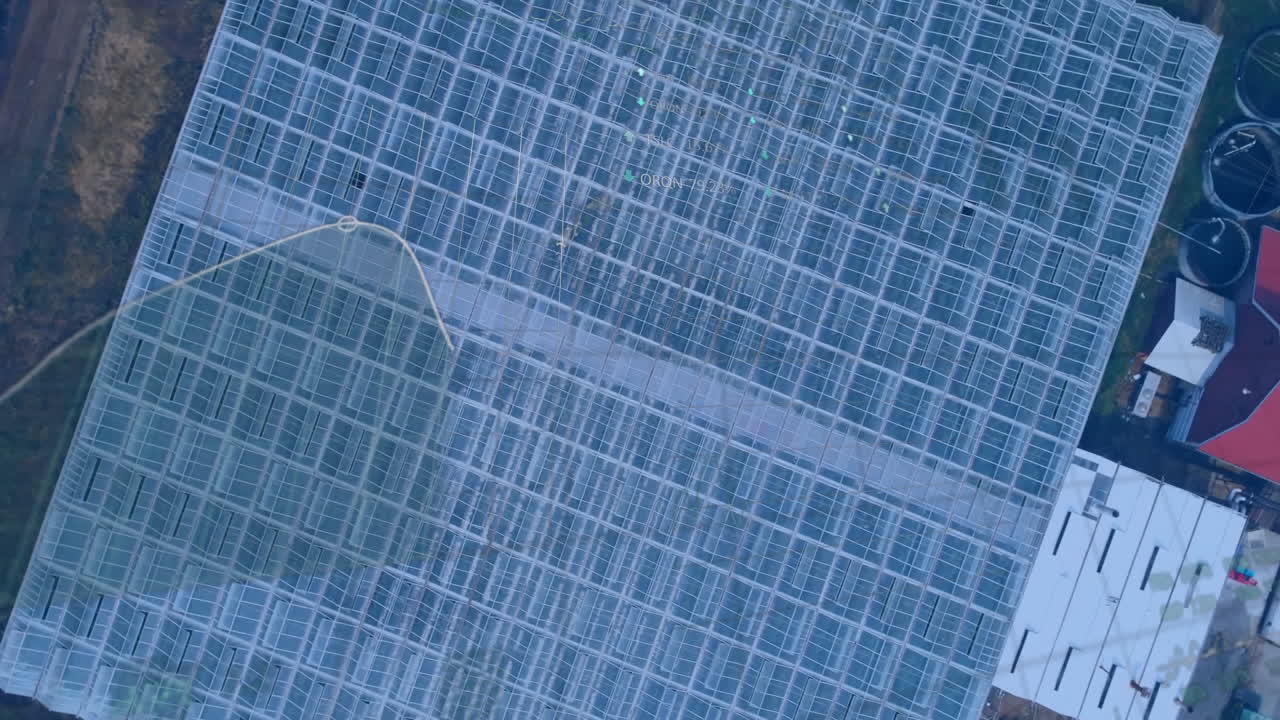 Greenhouse grid showing performance stats overlays in top-down view with red-roofed shed and tanks