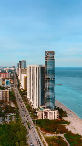 scenic view of luxurious miami, florida, usa on daytime. luxurious skyscrapers face the beautiful waterscape of the atlantic ocean. vertical video