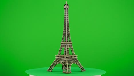 metal model figure of eiffel tower paris on green background chroma key background replacement backdrop objet in a turntable 3d spinning loop