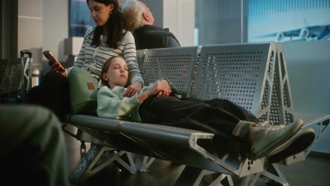 mother and daughter waiting at airport