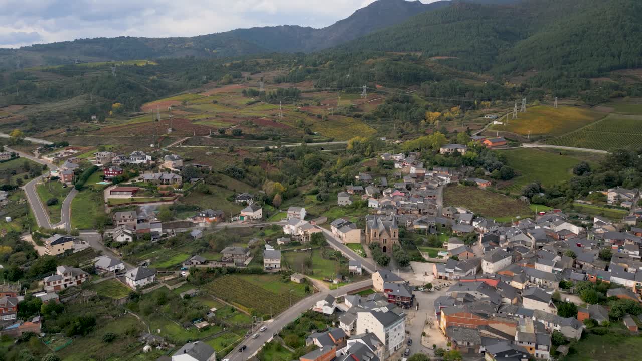 Drone aerial of town A Rúa, Ourense, Galicia, Spain with distant mountains visible