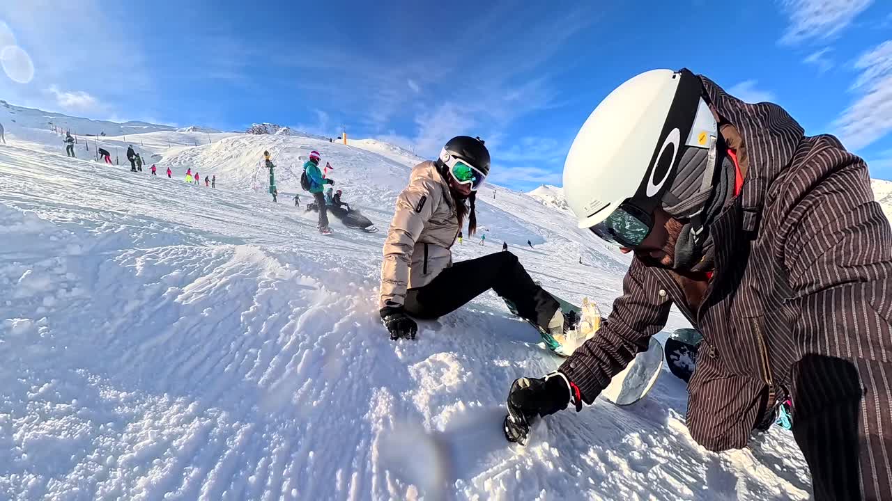 People snowboarding and skiing in a snowy mountain landscape