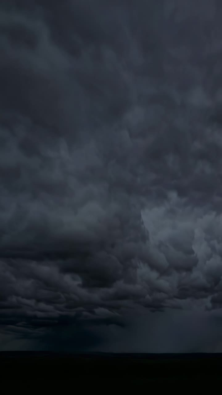 Dramatic low-angle video capturing a stormy sky with dark, swirling clouds and vivid lightning