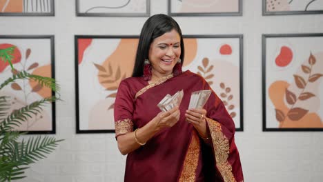 cheerful-Indian-woman-counting-money