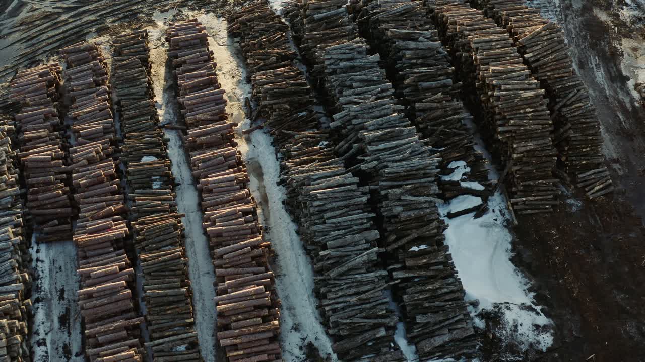 Overhead drone view of large stockpile of logs taken from Canadian forests in Thurso Quebec Canada during winter