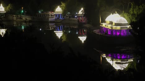 historical architecture decorated with ferry colorful lights and water reflection at night video is taken at udaipur rajasthan india.
