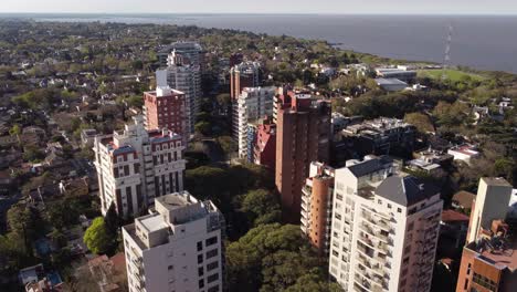 group of high-rise apartment buildings in front of river in vicente lopez,buenos aires