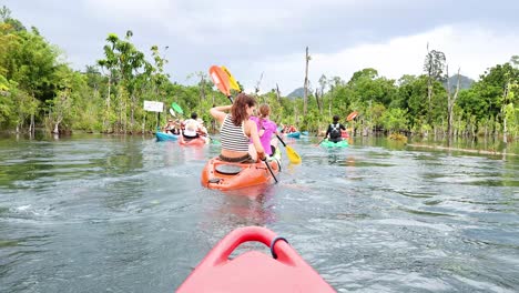 people kayaking through a scenic canal in krabi