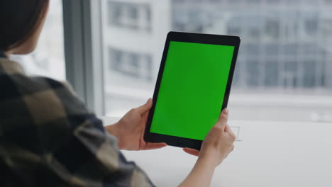 Girl-hands-watching-chromakey-tablet-at-city-windows-flat.-Woman-relaxing-pad