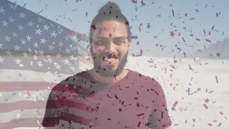 animation of flag of united states of america and confetti over biracial man on beach