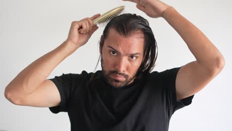 man-using-brush-on-his-head-with-baldness,-Hair-health