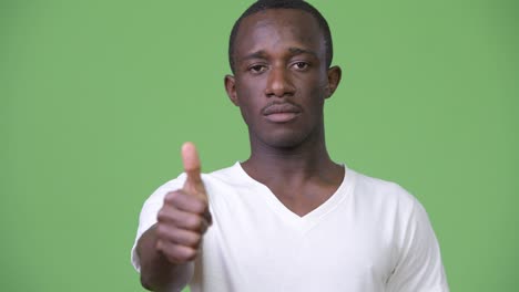 young african man giving thumbs up