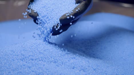 Slow-Motion-Shot-Of-Recycled-Blue-Plastic-Grains