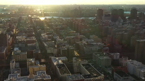 Epic-golden-hour-sunrise-drone-flight-over-Harlem,-Manhattan,-New-York-City