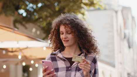 lovely woman using credit bank card smartphone while transferring money purchases online shopping