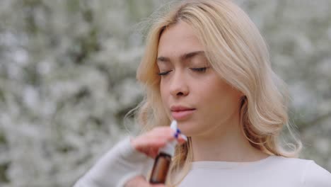 woman using nasal spray outdoors