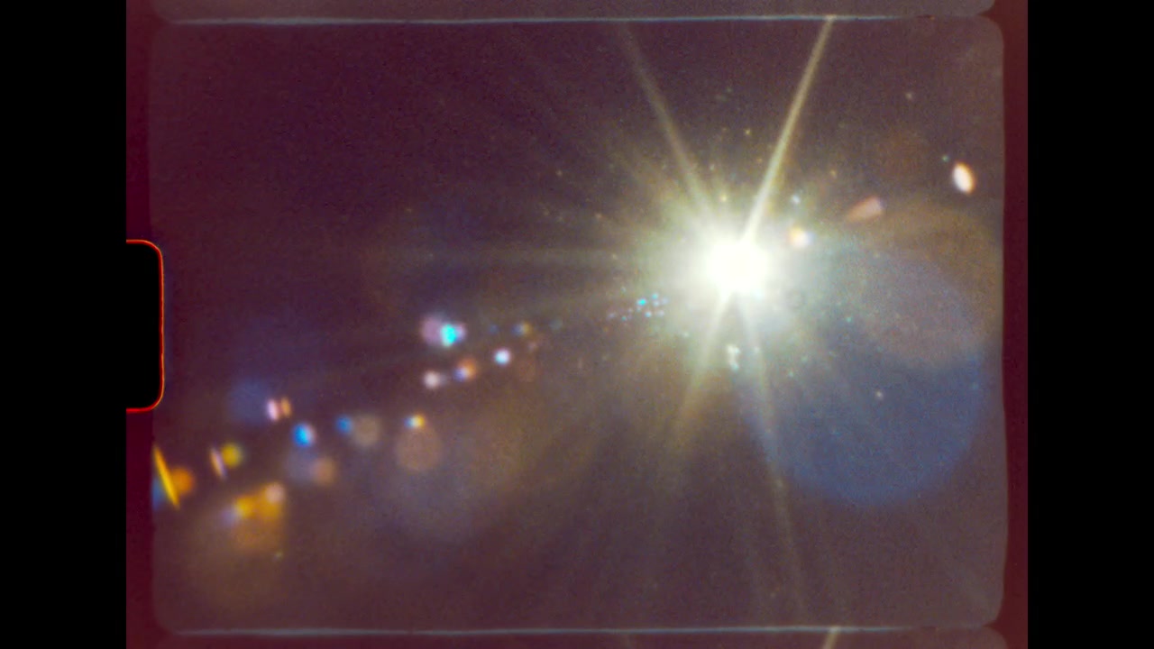 Airplane Flying Overhead Against Bright Sun with Lens Flare
