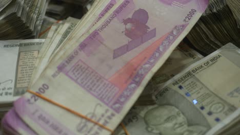 stack of indian rupee banknotes of different value, bundle of cash, lot of cash, 2000 and 500 rupee banknotes, closeup