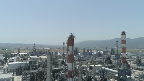 Aerial-footage-of-a-large-scale-Oil-refinery-with-smoke-stacks-and-petroleum-storage-tanks