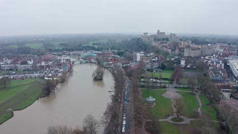 cinematic rotating aerial drone shot of thames river connecting eton and windsor