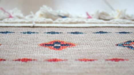 close-up of a colorful woven rug with geometric pattern