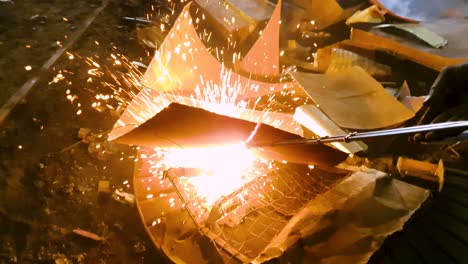 Gas cutter, cutting the metal scrap at scrapyard. Slow motion. Close up.