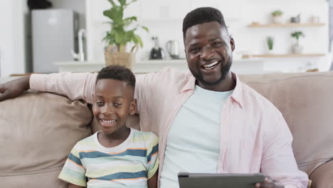 african american father and son smile in a home setting