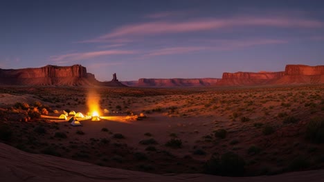 night camping under starry sky in desert landscape with campfire and tents
