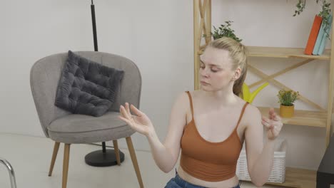 Woman Kneeling and Gesturing in a Room