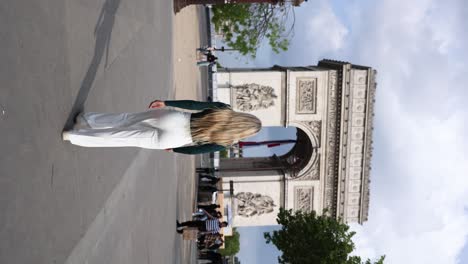 Female-Tourist-Visiting-the-Arc-de-Triomphe,-Sightseeing-Travel-Destination-in-Paris---Vertical