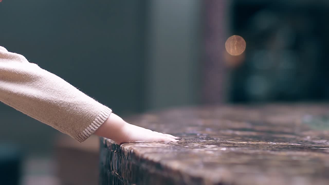 CU Slow motion Little sweet girl playing with water near fountain 1 Sprays water with a hand