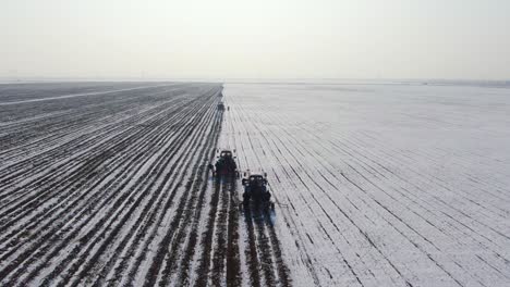 Farming-Tractors-Cultivating-The-Snowfield-During-Winter-In-Ukraine