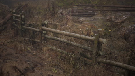 an old wood fence with a country field behind it