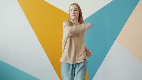 young woman dancing in a colorful studio