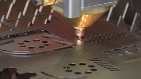 cnc laser cutting of metal, modern industrial technology. small depth of field. warning - authentic shooting in challenging conditions.