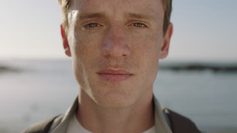 close-up-portrait-of-handsome-young-man-looking-thoughtful-pensive-on-seaside-background