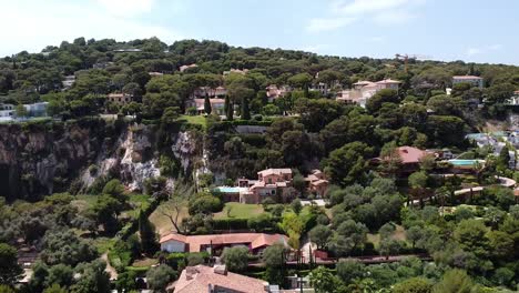 arial shot revealing houses on cliff in nice then pan tilt down to beautiful